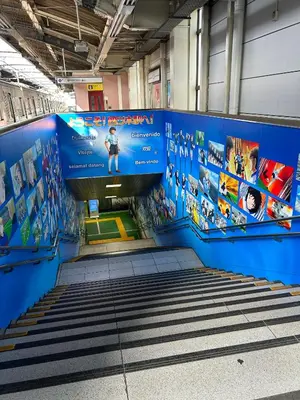 a staircase in a subway station with a blue wall at 3-min to Station,5BR, 1LR villa near Asakusa, 95\u5e73\u7c735\u95f4\u5367\u5ba4\u4f11\u606f\u597d Stay Dream Hotel in Tokyo