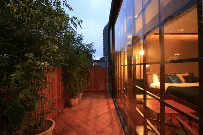 a balcony with potted plants on a building at Studio-D in Tokyo