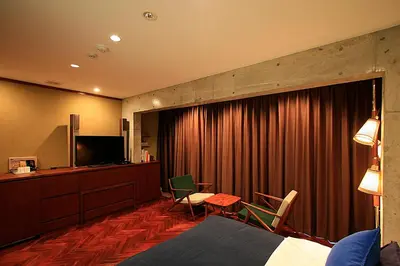 a hotel room with a bed and a television at Studio-D in Tokyo