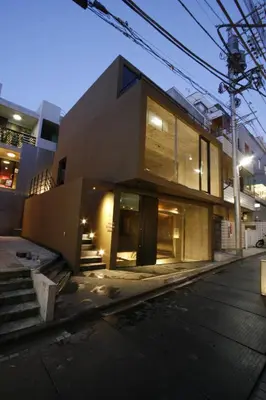 a house on a street at night with lights at Studio-D in Tokyo