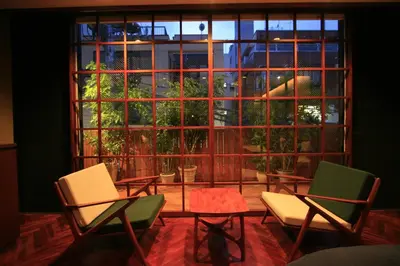 a room with a table and chairs and a large window at Studio-D in Tokyo