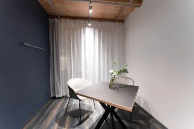 a table with two chairs and a vase of flowers on it at Corent\u4ee3\u7530\u6a4b in Tokyo