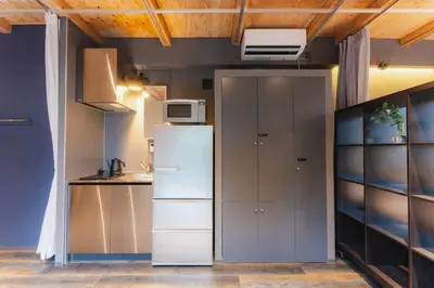 a kitchen with a refrigerator and a microwave at Corent\u4ee3\u7530\u6a4b in Tokyo
