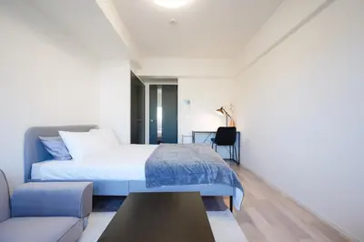 a bedroom with a bed and a couch at unito KEIKYU-KAMATA in Tokyo