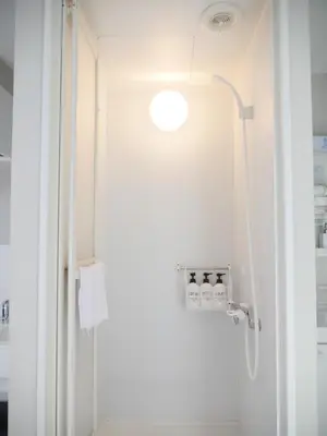 a bathroom with a shower with a glass door at 9stay\u8535\u524d in Tokyo