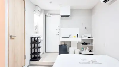 a white room with a bed and a sink at 9stay\u8535\u524d in Tokyo