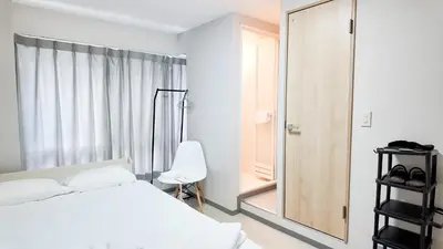 a bedroom with a white bed and a mirror at 9stay\u8535\u524d in Tokyo