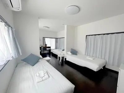 a hotel room with two beds and a desk at D\u65c5\u9928\u3000Dryokan in Tokyo
