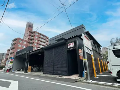 a black building on the side of a street at D\u65c5\u9928\u3000Dryokan in Tokyo