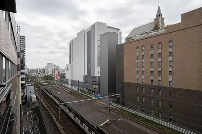 a view of a city with buildings and train tracks at \u5927\u585a\u99c51\u5206\uff01\u6c60\u888b\u30a8\u30ea\u30a2\uff01\u30b0\u30eb\u30fc\u30d7\u65c5\u884c\u306b\u6700\u9069 in Tokyo