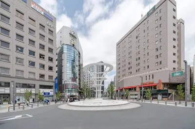 a street in a city with tall buildings and a fountain at \u5927\u585a\u99c51\u5206\uff01\u6c60\u888b\u30a8\u30ea\u30a2\uff01\u30b0\u30eb\u30fc\u30d7\u65c5\u884c\u306b\u6700\u9069 in Tokyo