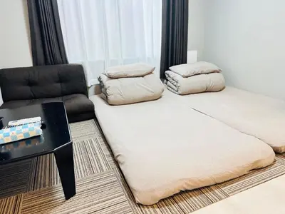 a bed and a chair in a room at Marvelous Koiwa - Vacation STAY 44643v in Tokyo