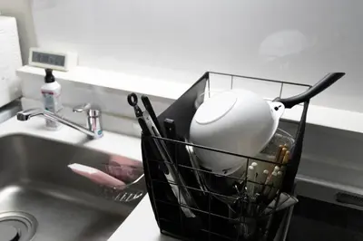 a basket of kitchen utensils next to a sink at EMILIO Nishi-Shinjuku Room 401 - Vacation STAY 89570v in Tokyo