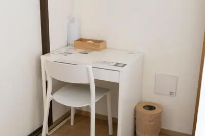 a small white desk with a chair and a box at EMILIO Nishi-Shinjuku Room 401 - Vacation STAY 89570v in Tokyo