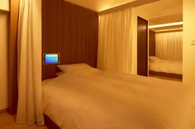 a bedroom with a large bed and a mirror at EMILIO Nishi-Shinjuku Room 401 - Vacation STAY 89570v in Tokyo