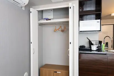 a kitchen with a door leading into a pantry at SLEEPLAB THE STAY Nishi-Shinjuku - Vacation STAY 89579v in Tokyo