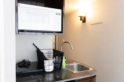 a kitchen counter with a sink and a microwave at SLEEPLAB THE STAY Nishi-Shinjuku - Vacation STAY 89579v in Tokyo