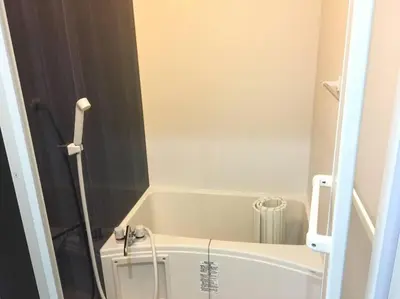 a small bathroom with a tub and a toilet at 401 Oshiage sta 3mins walk! Wi-Fi Elevator 4pax in Tokyo