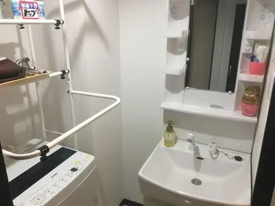 a white bathroom with a sink and a mirror at 401 Oshiage sta 3mins walk! Wi-Fi Elevator 4pax in Tokyo