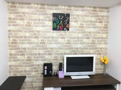 a television sitting on a table in front of a brick wall at *301 Oshiage sta 3mins walk! Wi-Fi Elevator in Tokyo