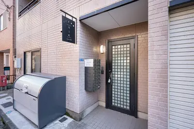 a building with a refrigerator on the side of it at ZAITO Tokyo Luna Lane Inn \u83ca\u5ddd\u99c5\u304b\u3089\u5f92\u6b695\u5206 in Tokyo