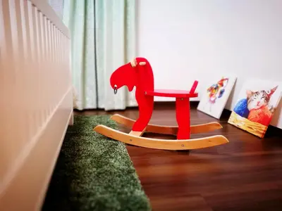 a red rocking chair sitting in a room at 新宿顶级奢华三层独栋别墅/车站5分钟/儿童房/8人 in Tokyo
