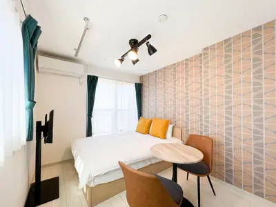 a small bedroom with a bed and a table at J'sコート落合 in Tokyo
