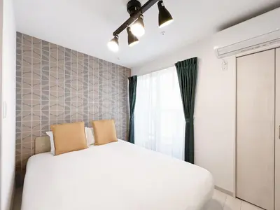 a bedroom with a white bed and a ceiling fan at J'sコート落合 in Tokyo