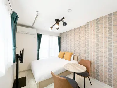 a small bedroom with a bed and a table at J'sコート落合 in Tokyo
