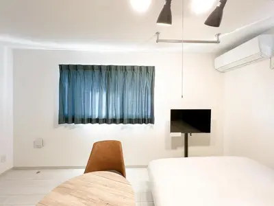 a room with a bed and a chair and a television at J'sコート落合 in Tokyo