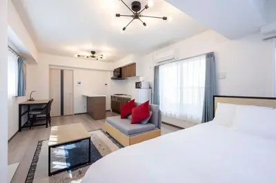 a bedroom with a bed and a living room at \u30ab\u30fc\u30b5\u30d6\u30e9\u30f3 in Tokyo