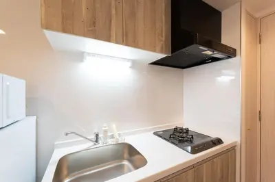 a kitchen with a sink and a stove at \u30ab\u30fc\u30b5\u30d6\u30e9\u30f3 in Tokyo