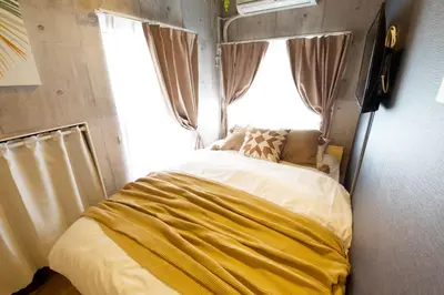 a bed in a room with a window at EDIFICE SHIBUYA301 in Tokyo