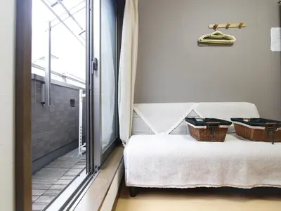 a room with a bed with two baskets on it at \u548c\u8cb4\u30d3\u30eb in Tokyo
