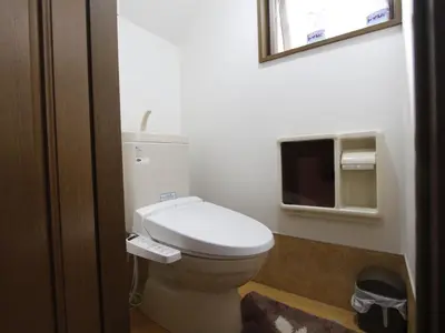 a bathroom with a toilet and a tv on the wall at \u548c\u8cb4\u30d3\u30eb in Tokyo