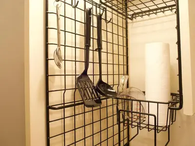 a metal rack with utensils hanging on a wall at The Hotel SPACE \u4e0b\u5317\u6ca2 in Tokyo