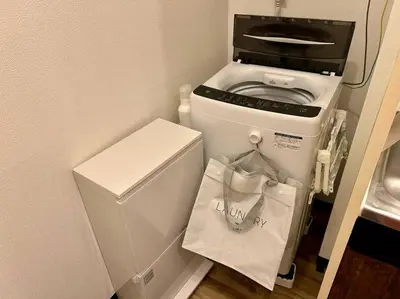 a small kitchen with a refrigerator and a microwave at The Hotel SPACE \u4e0b\u5317\u6ca2 in Tokyo