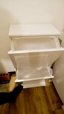 a person is reaching inside of an empty refrigerator at The Hotel SPACE \u4e0b\u5317\u6ca2 in Tokyo