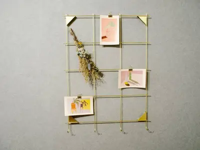 a shelf with pictures on it on a wall at The Hotel SPACE \u4e0b\u5317\u6ca2 in Tokyo