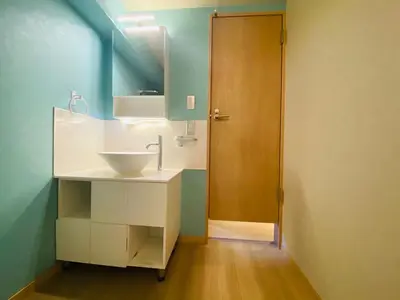 a bathroom with a sink and a wooden door at Ueno house-TT0135 in Tokyo