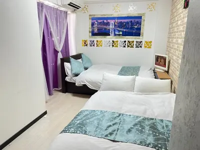 two beds in a room with purple and white at 503 Oshiage sta 3mins walk! Wi-Fi & Elevator 4pax in Tokyo
