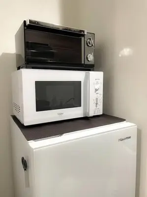 a microwave sitting on top of a refrigerator at 503 Oshiage sta 3mins walk! Wi-Fi & Elevator 4pax in Tokyo
