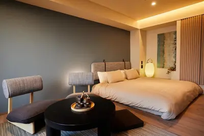 a hotel room with two beds and a table and a table at LiveGRACE Hotel Azabu \u9ebb\u5e03\u829d\u516c\u5712 in Tokyo