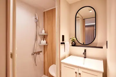 a bathroom with a sink and a mirror at LiveGRACE Hotel Azabu \u9ebb\u5e03\u829d\u516c\u5712 in Tokyo