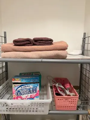 a shelf with towels and baskets and a towel at 403 Oshiage sta 3mins walk! Wi-Fi & Elevator 4pax in Tokyo