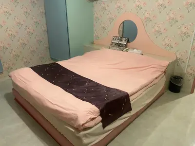 a small bed in a room with a mirror at \u30db\u30c6\u30eb\u30d5\u30a9\u30fc\u30e9\u30e0 in Tokyo