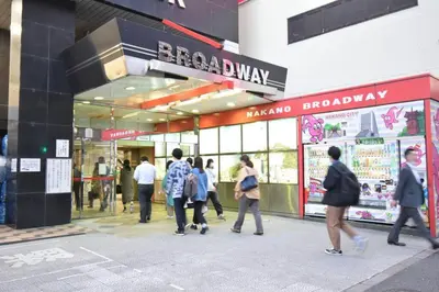 a group of people walking in front of a store at \u30a2\u30f3\u30c9\u30b9\u30c6\u30a4\u4e2d\u91ce5\u4e01\u76ee203 in Tokyo