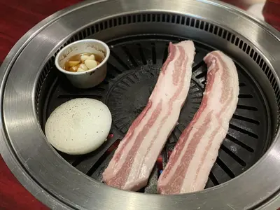 two pieces of bacon and a egg in a slow cooker at Hotel RIO\u65b0\u5bbf in Tokyo
