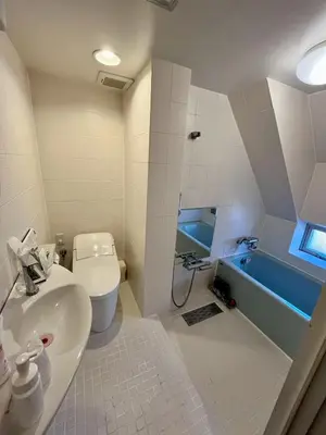 a bathroom with a sink and a toilet and a tub at Hotel RIO\u65b0\u5bbf in Tokyo