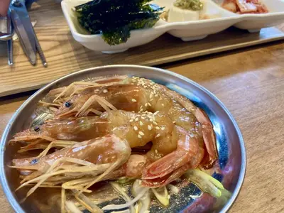 a bowl of shrimp and noodles on a table at Hotel RIO\u65b0\u5bbf in Tokyo